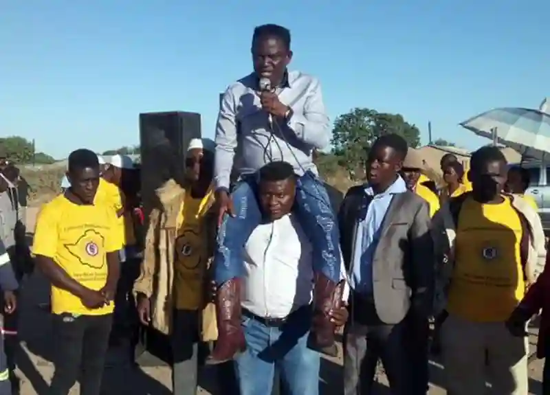 Mugabe Party Candidate Addresses Rally On Bodyguard's Shoulders, Says ED Is Cruel