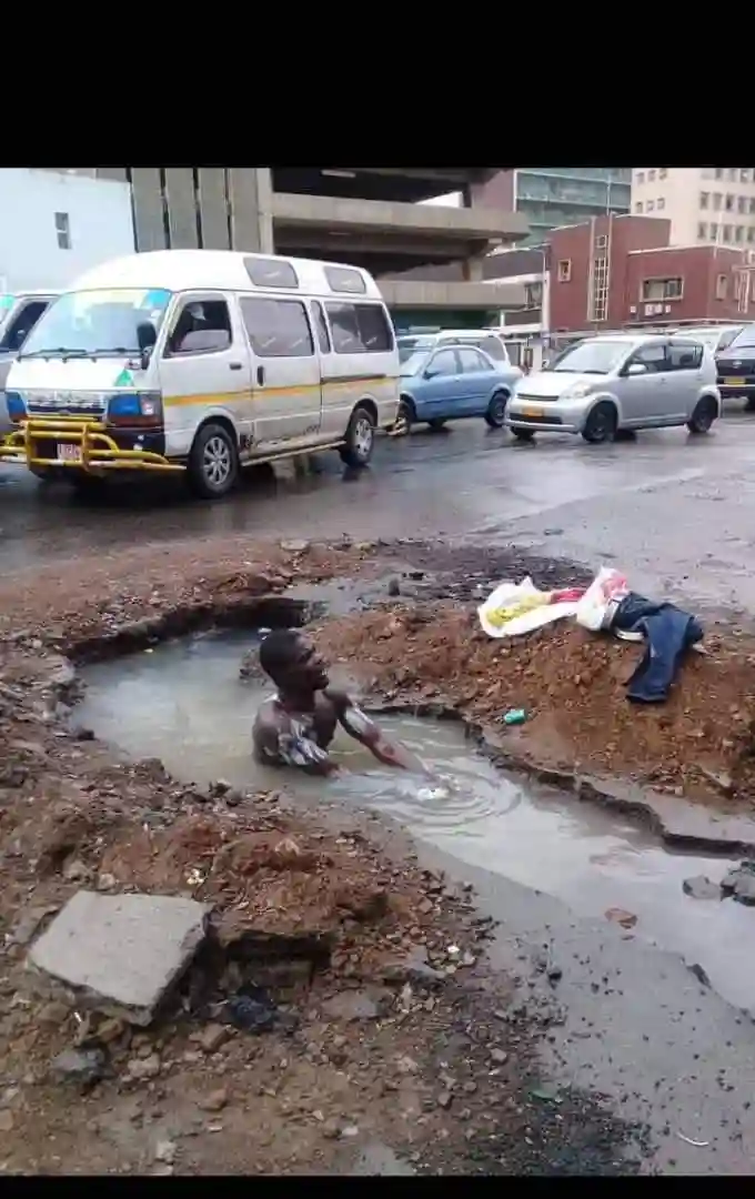 WATCH: Harare Man Takes Bath In City Council Ditch Middle Of CBD